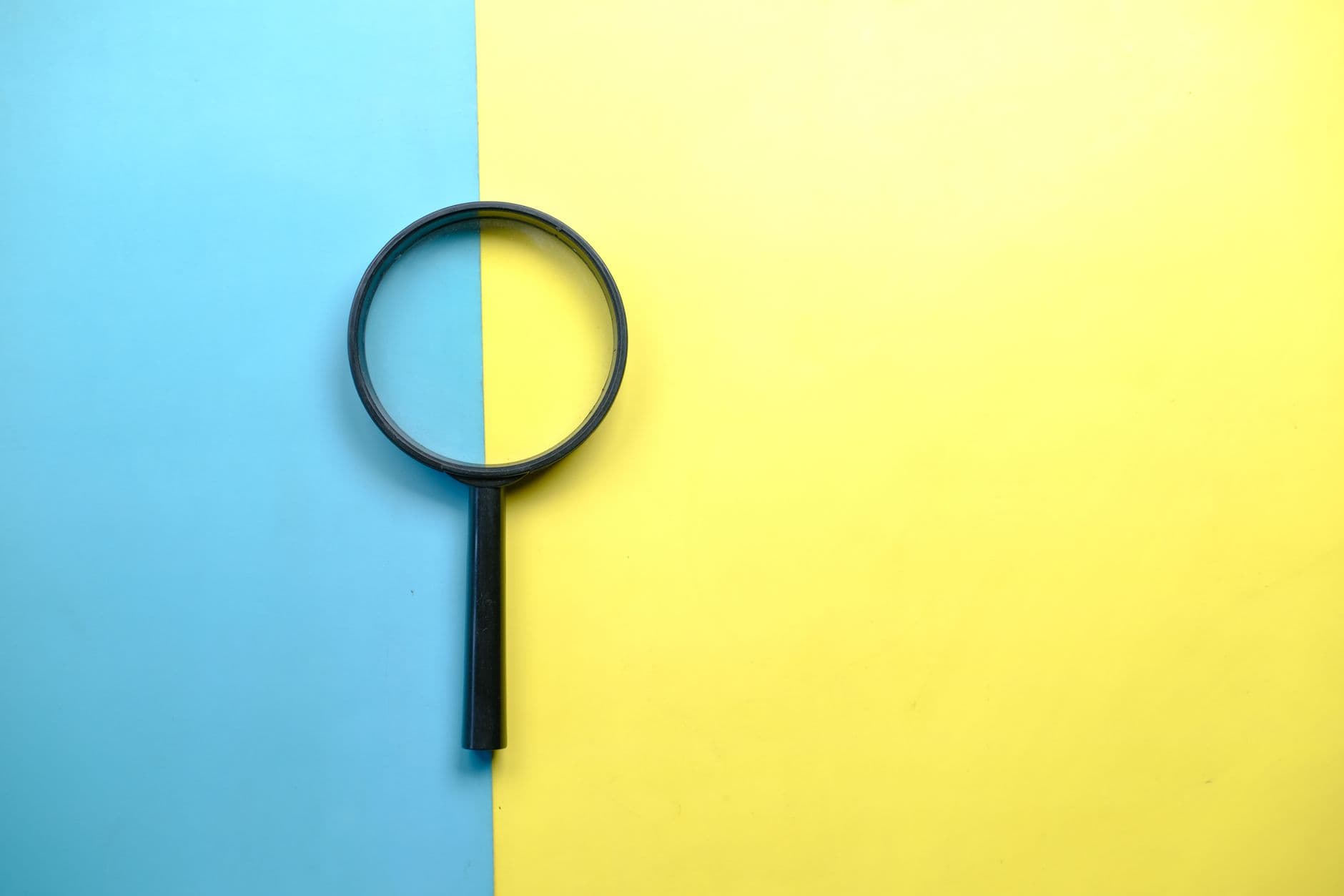 A magnifying glass on a split-colour ground