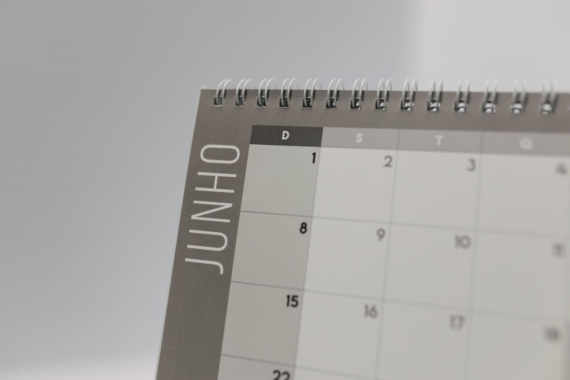A desk calendar open to a month grid