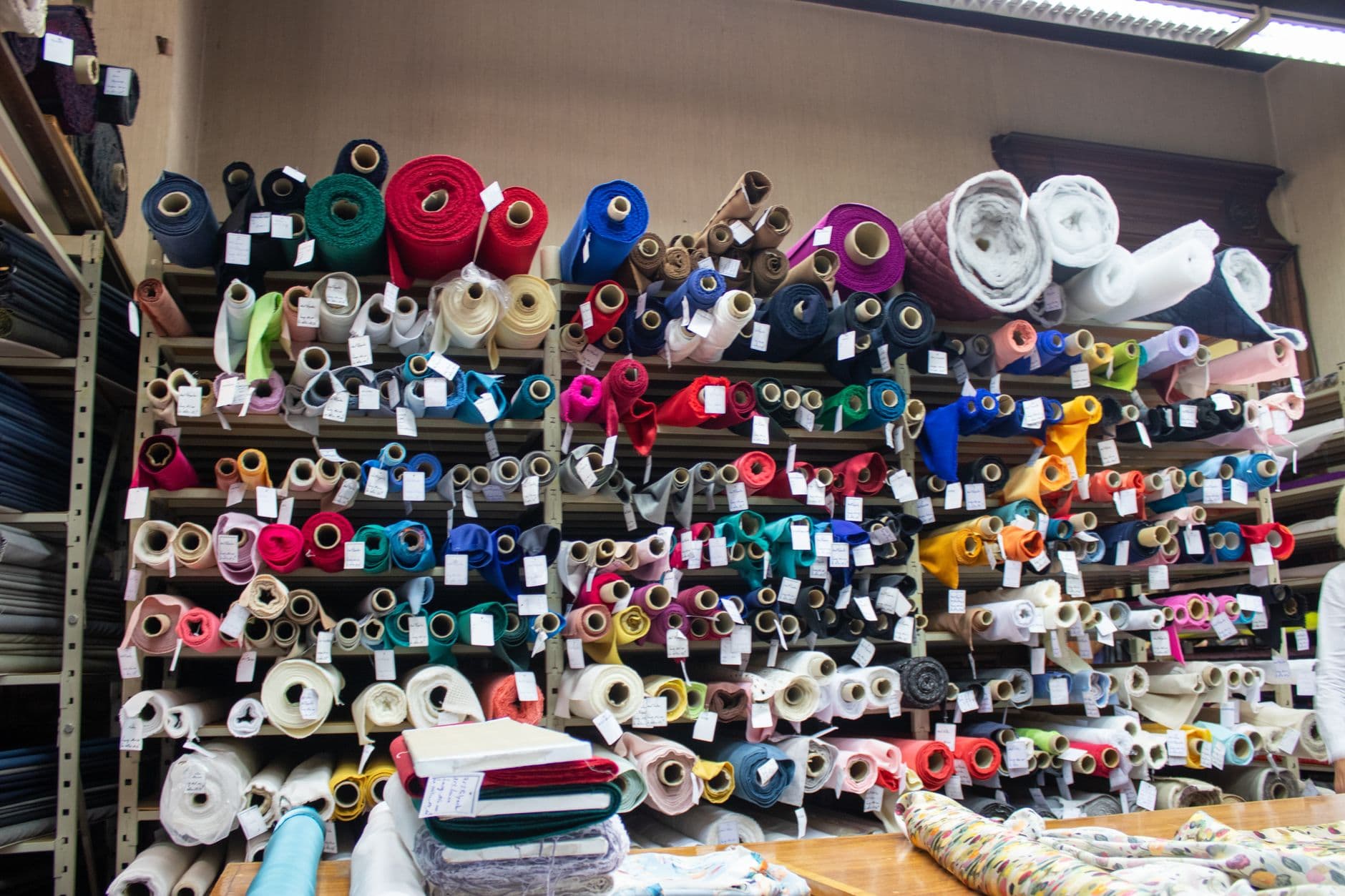 Bolts of fabric filling shop shelving