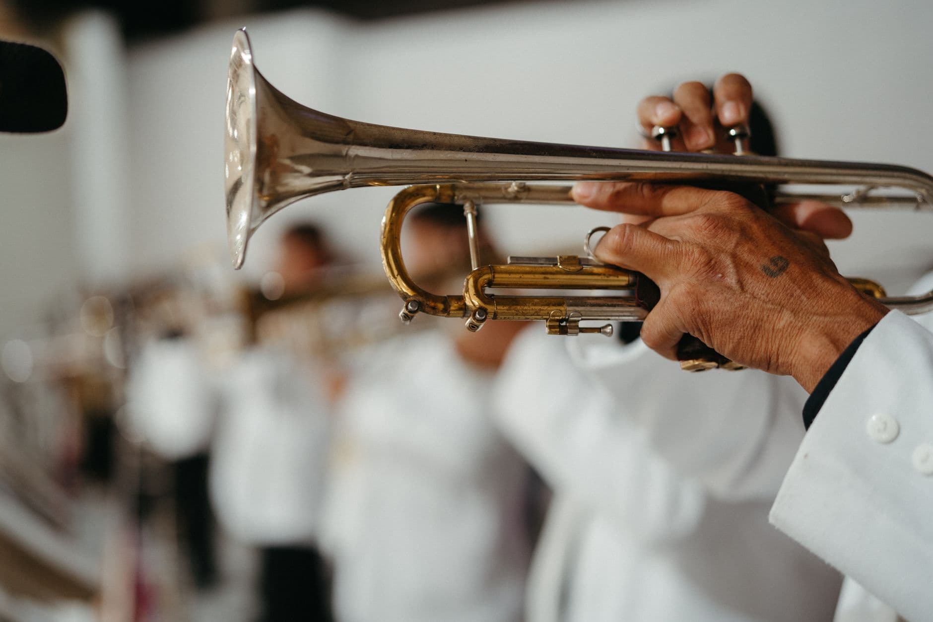 A player in a brass section, mid-performance