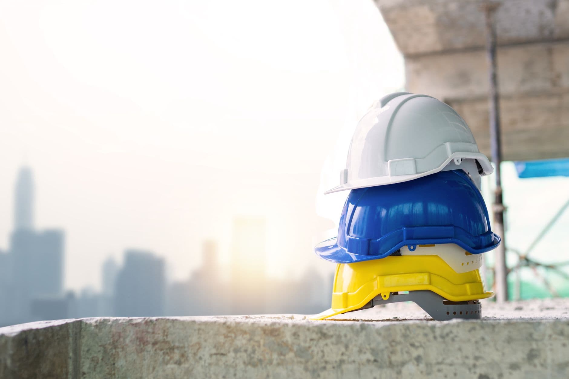 Safety helmets stacked against a bright skyline