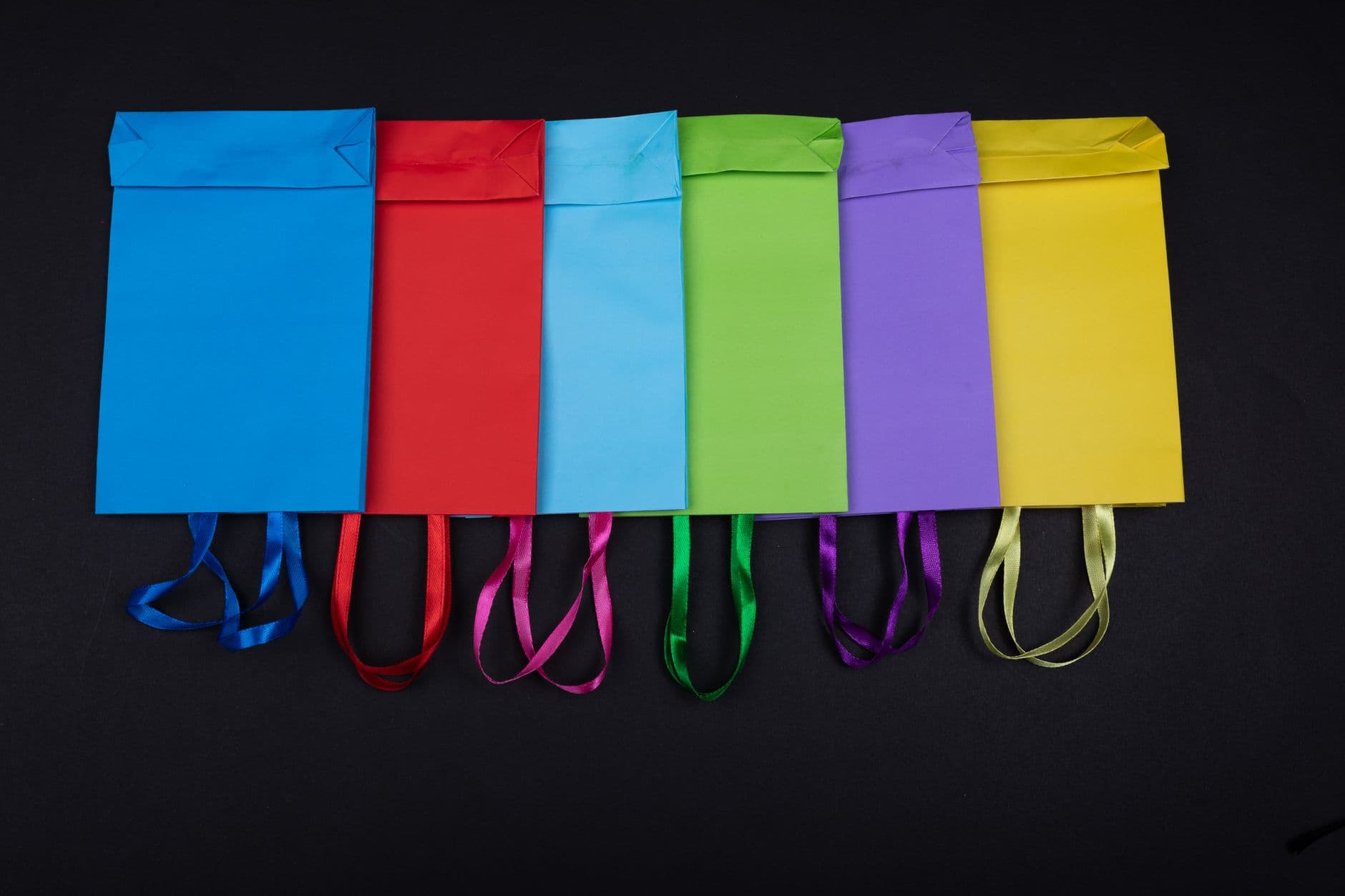 Plain paper carrier bags in a row of colours