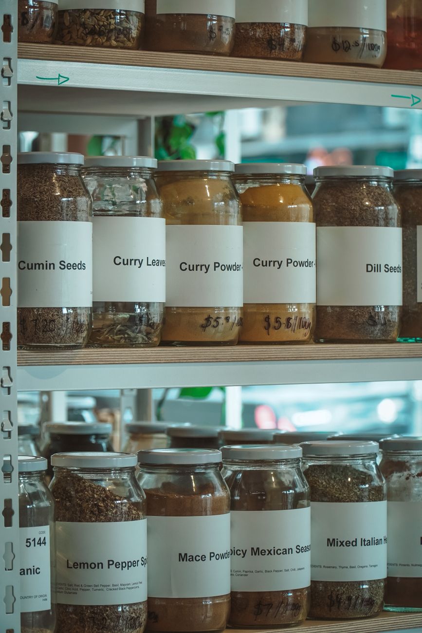Labelled spice jars on shop shelving