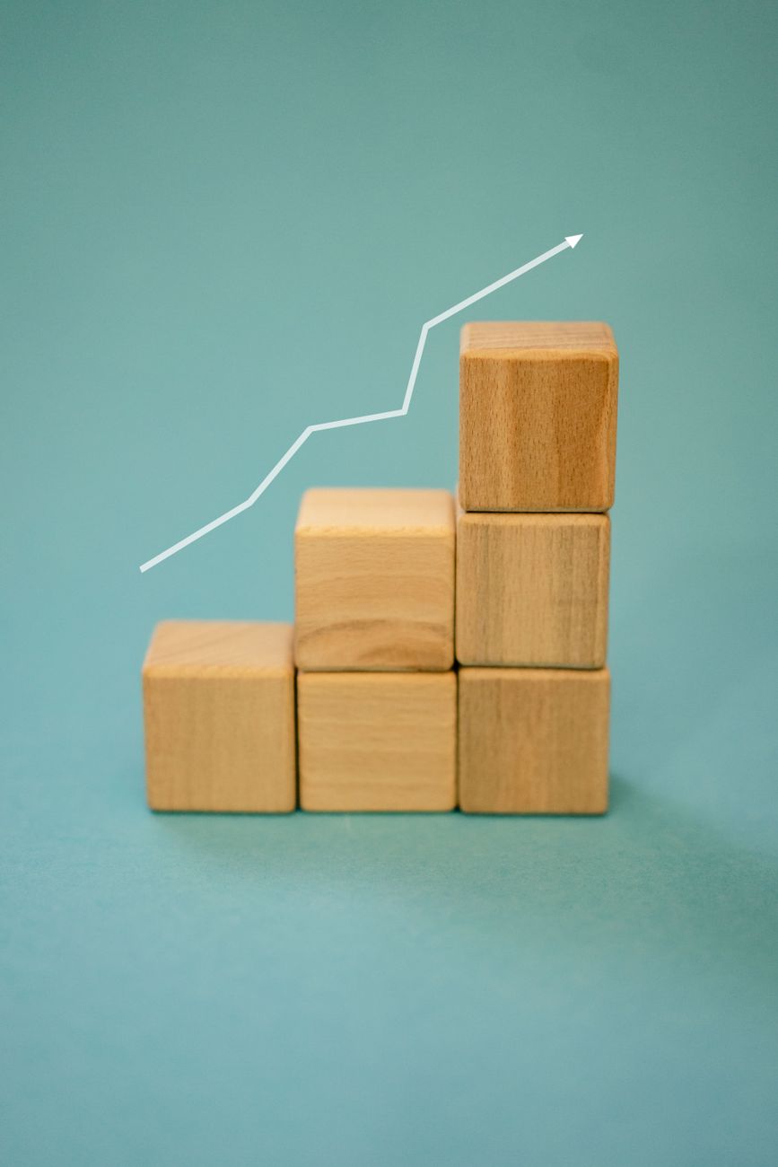 Wooden blocks stepped beneath a rising trend line