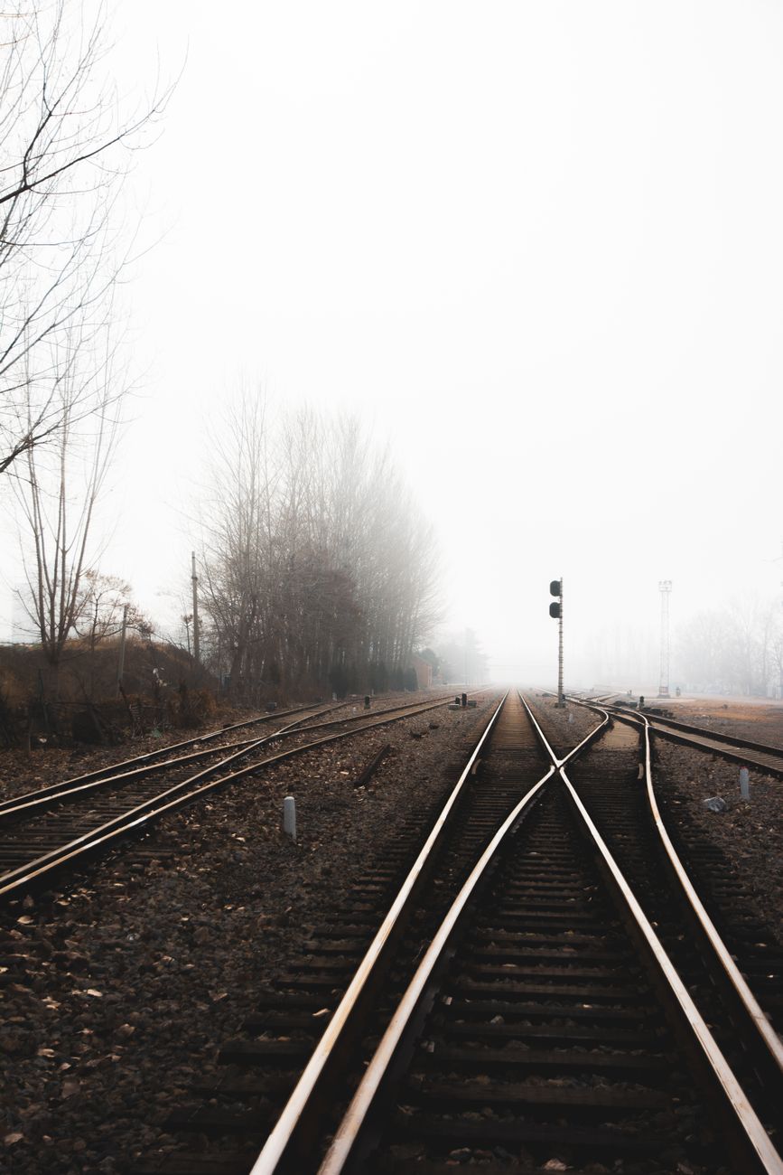 Two railway tracks converging in fog
