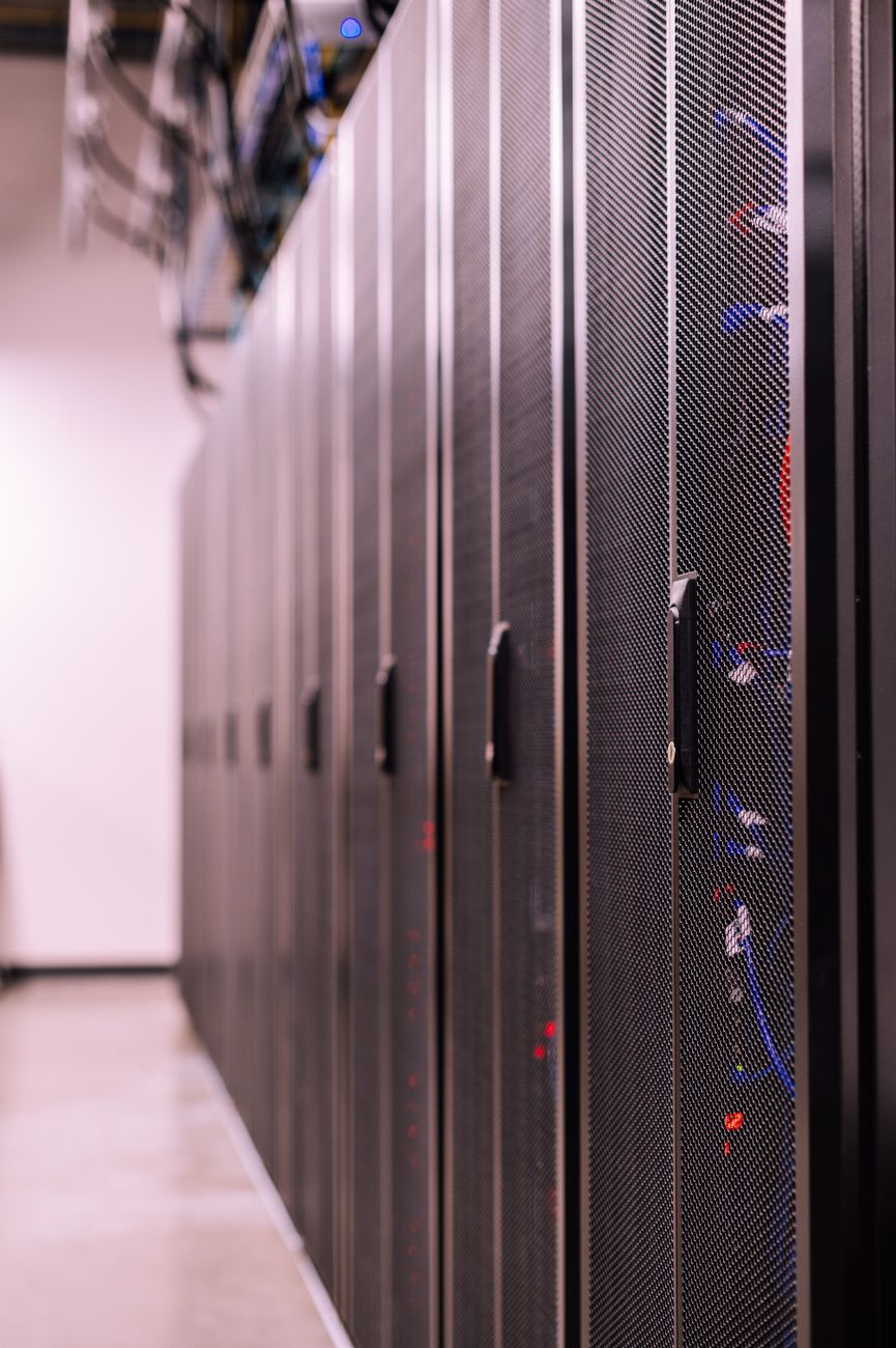 A row of racked servers in a data centre aisle