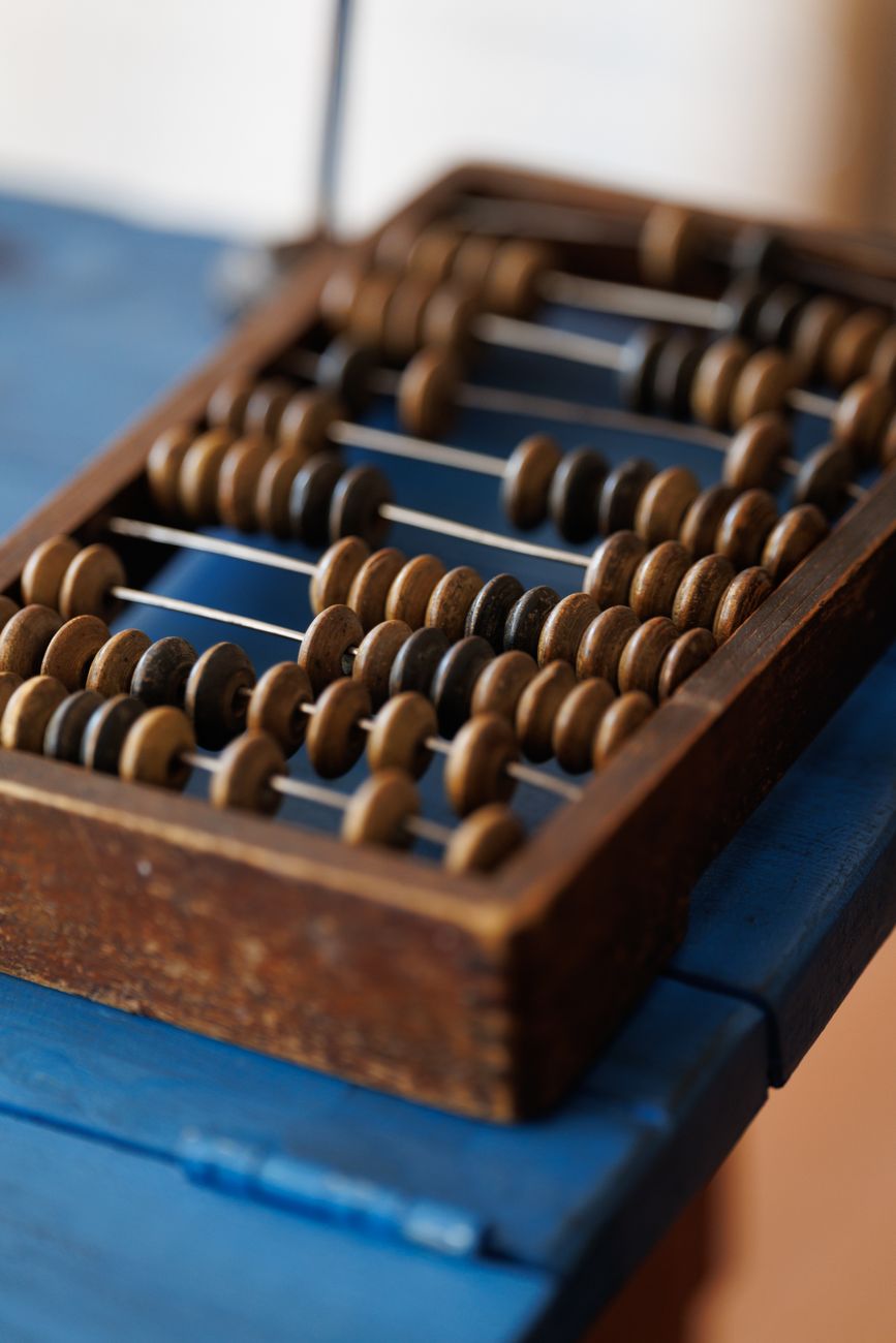 A wooden abacus on a blue table