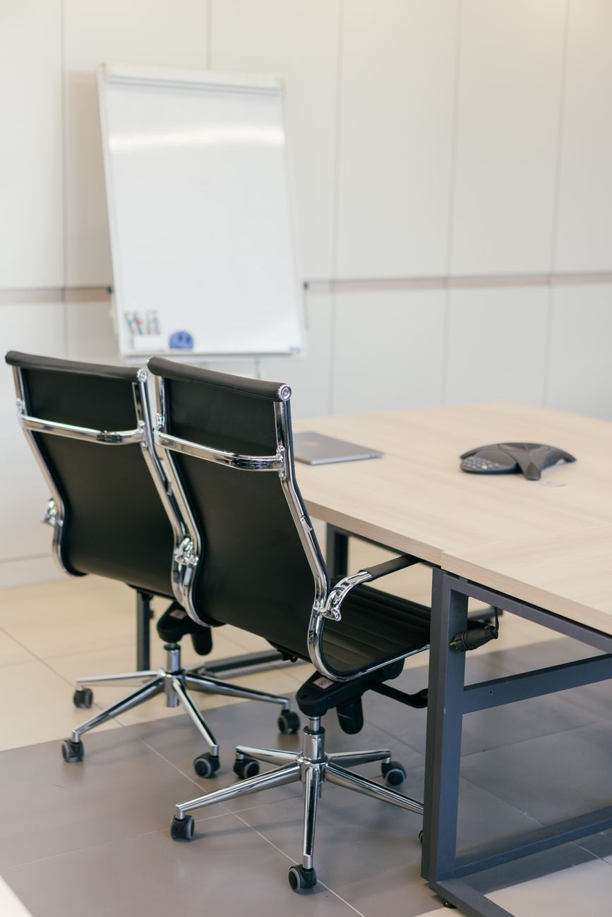 Two empty chairs at a meeting table