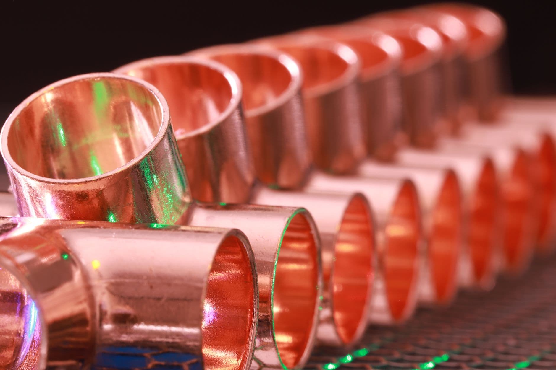 Copper pipe fittings in gleaming rows