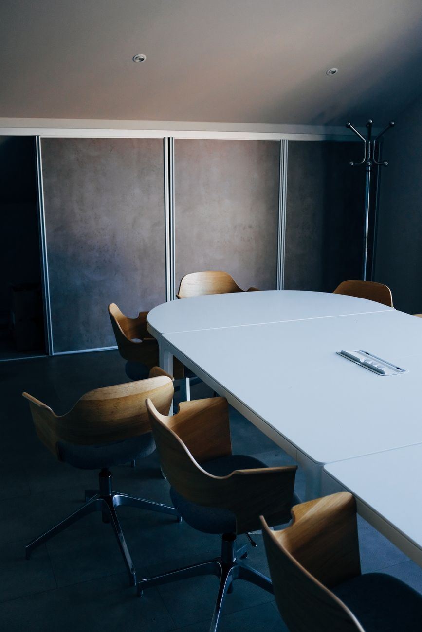 An empty meeting table with chairs