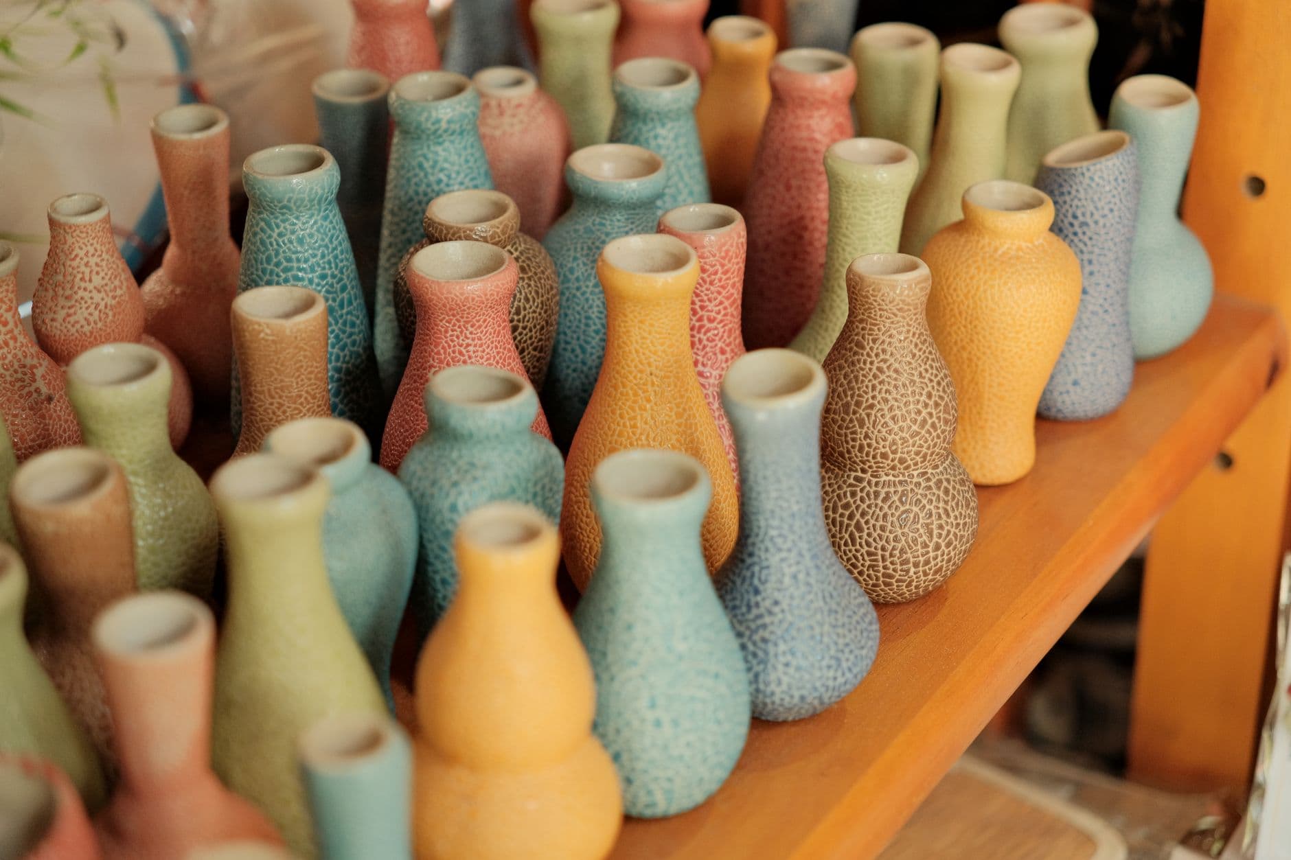 Ceramic pieces lined up on a shelf