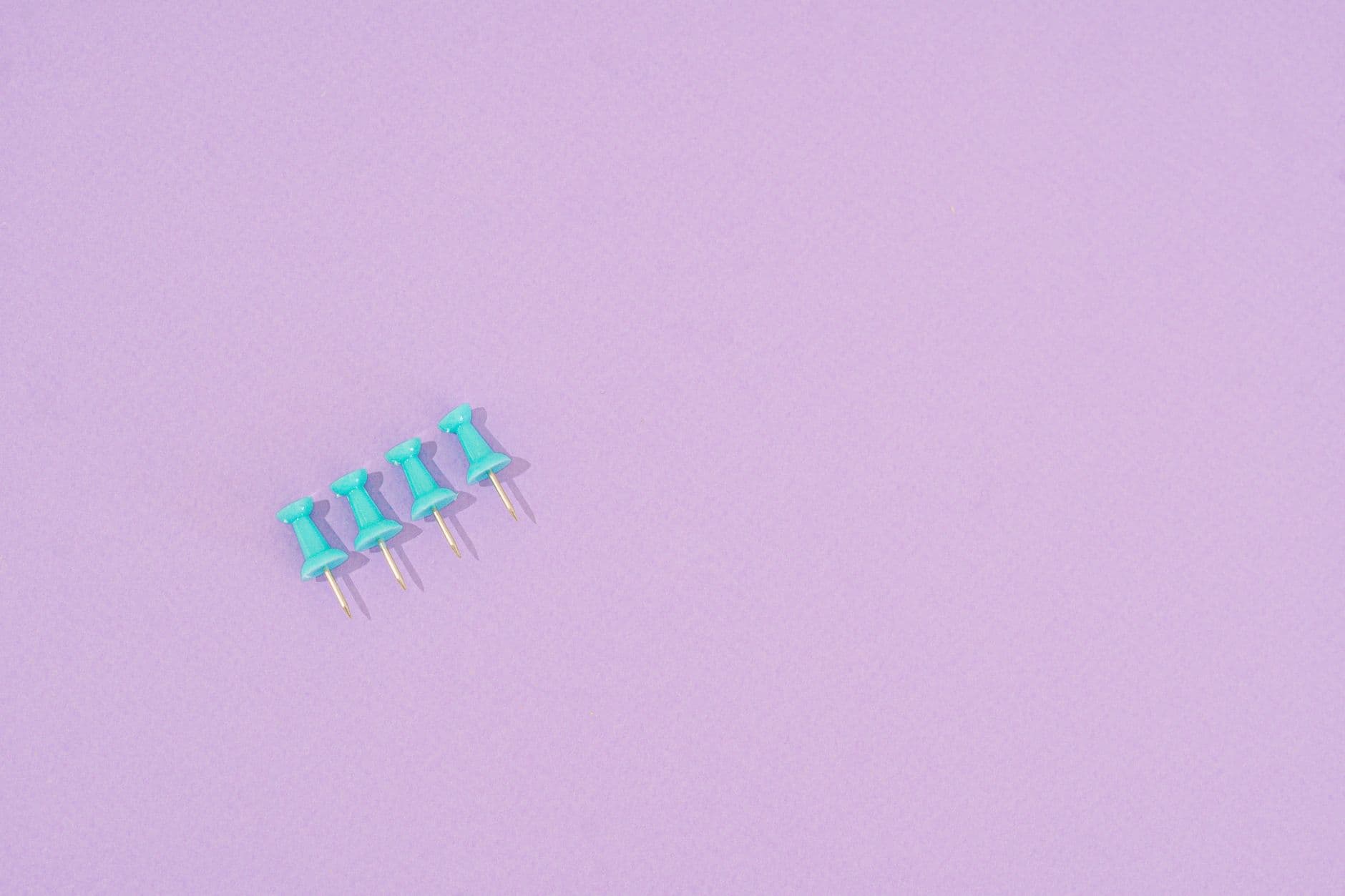 Four pins on a coloured ground