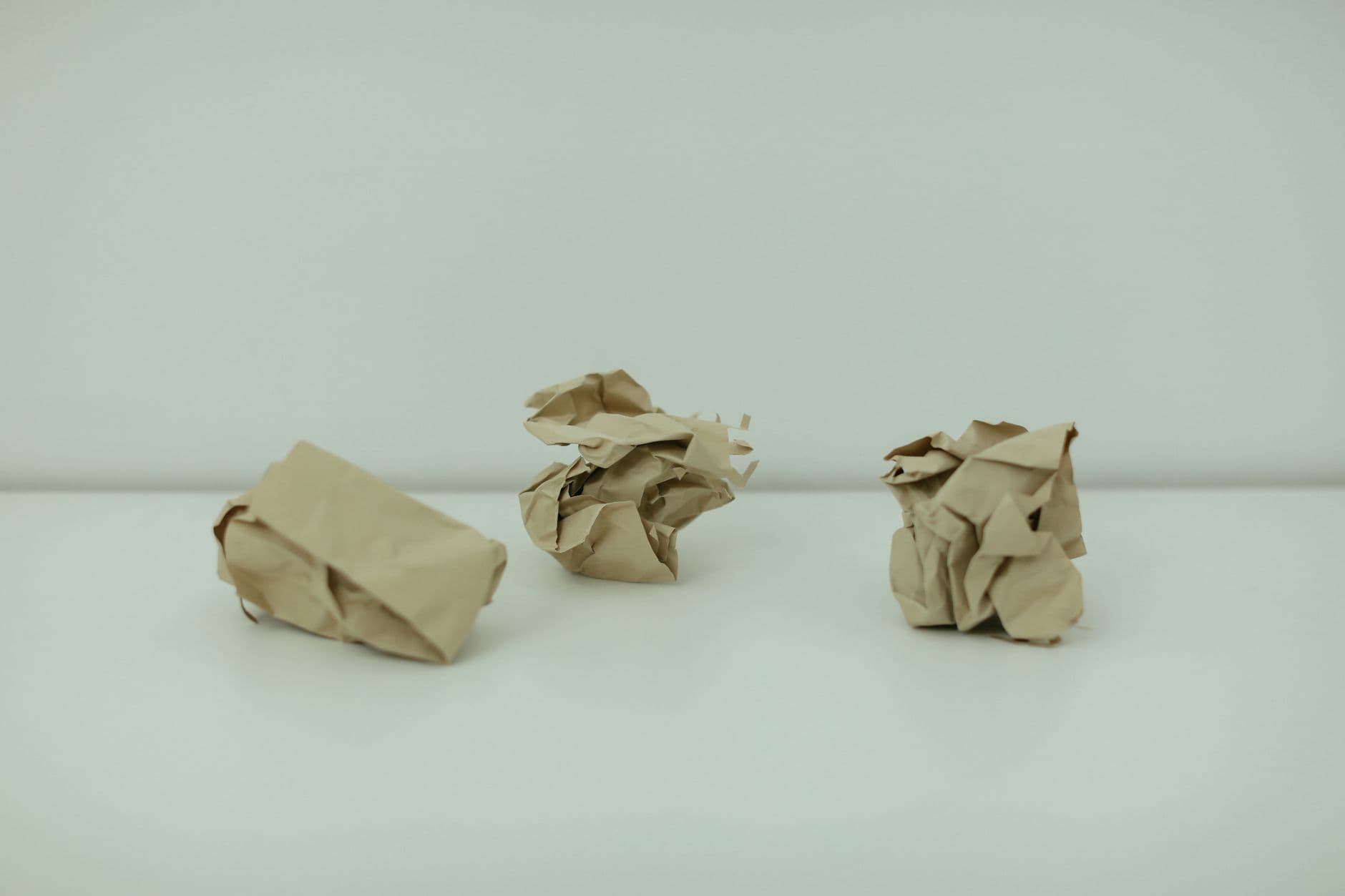 A single crumpled sheet of paper on a white ground