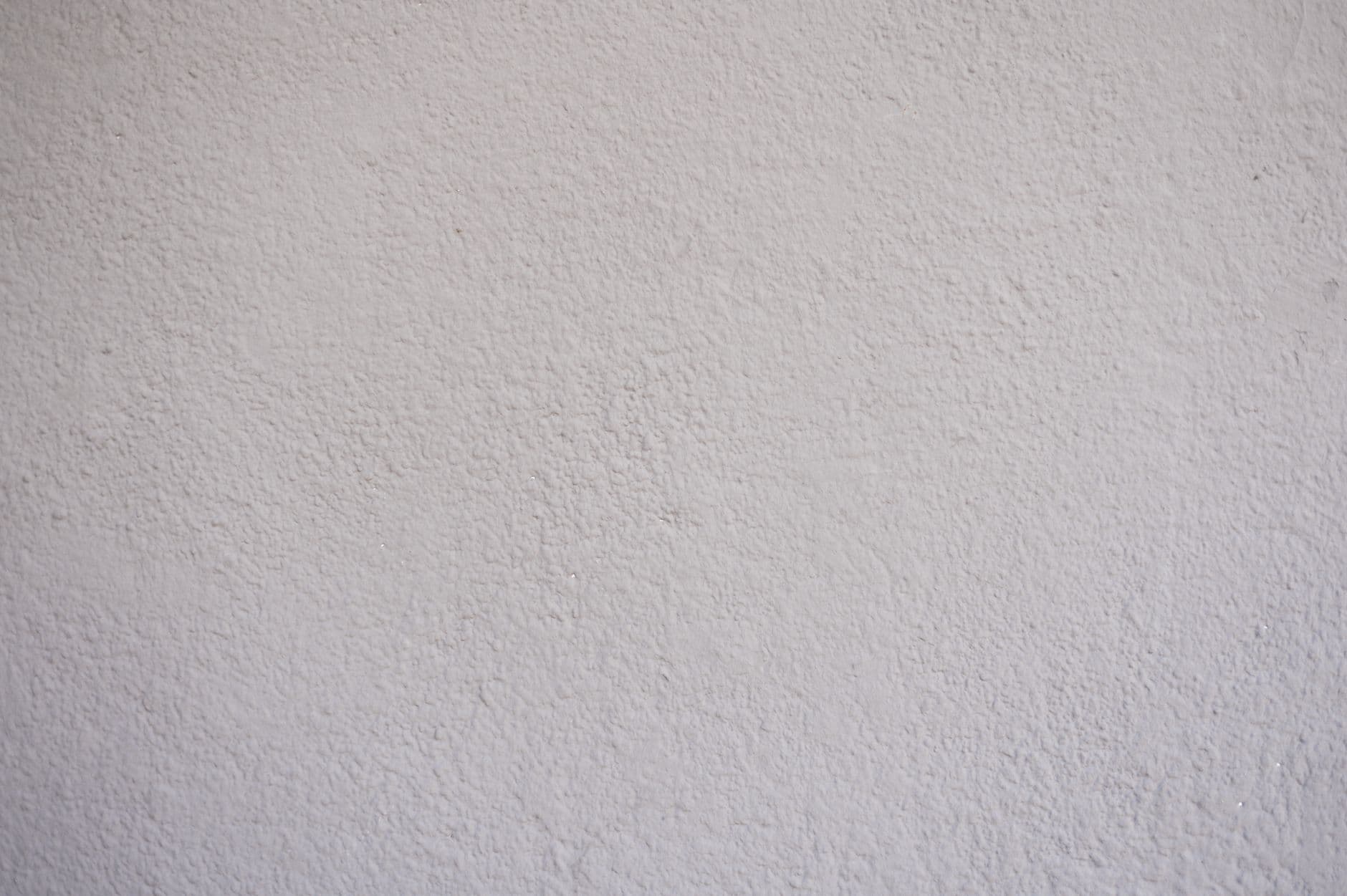 A smooth, unmarked white plaster wall